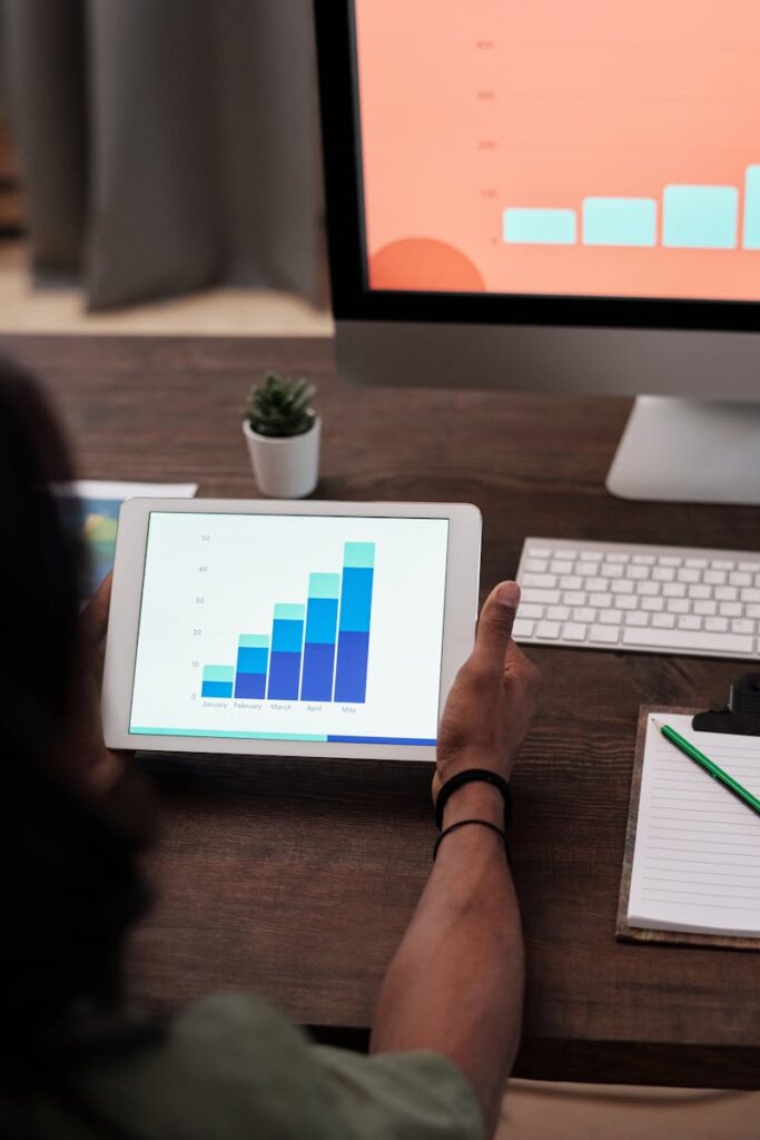pexels-photo-6476590-6476590 A person reviews statistical graphs on a tablet, showcasing data analysis and technology.